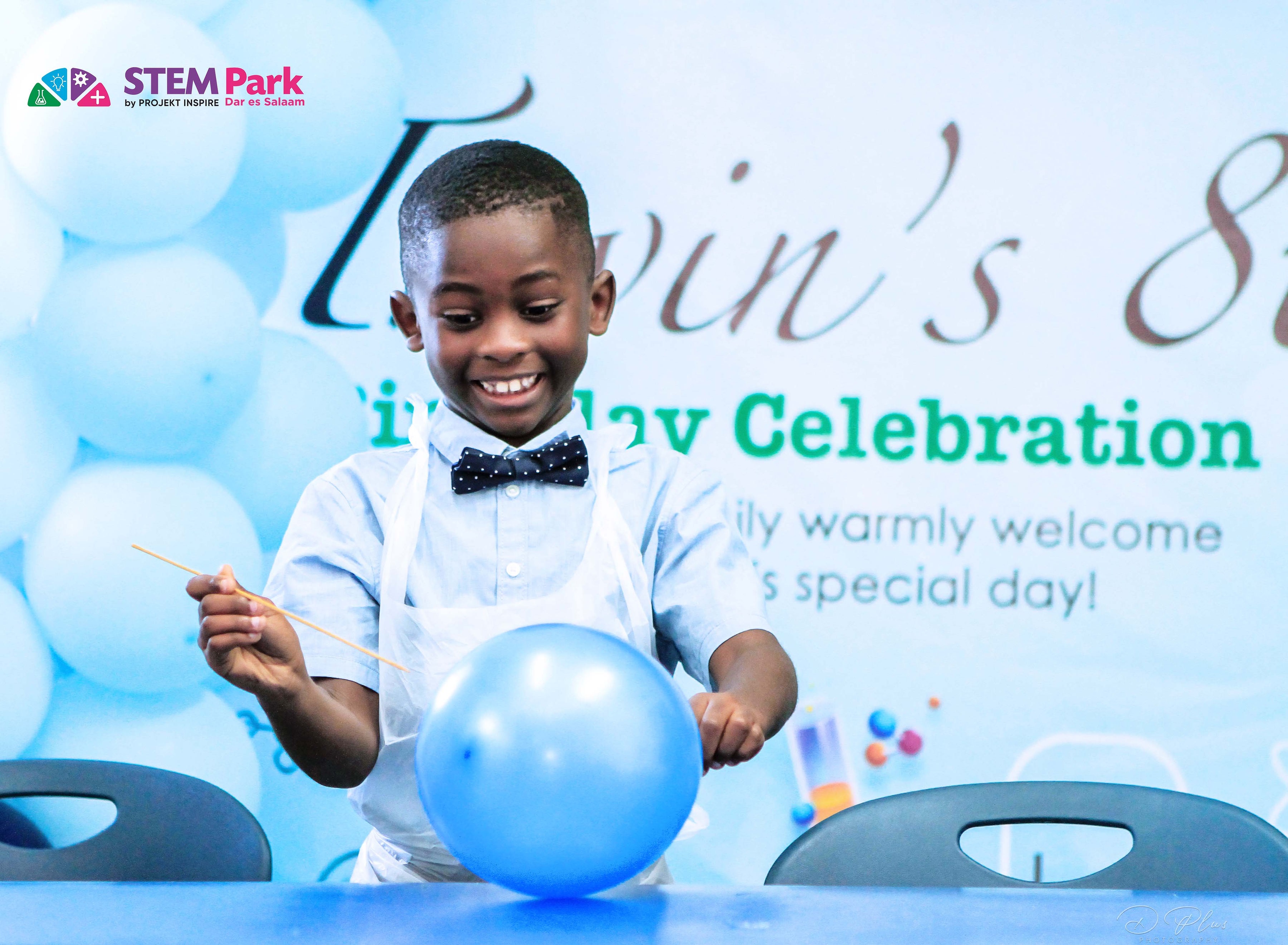 A child enjoying a hands-on experiment during a STEM birthday experience